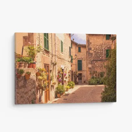 Cuadro en lienzo calle mediterránea con macetas y luz dorada – Pixers®