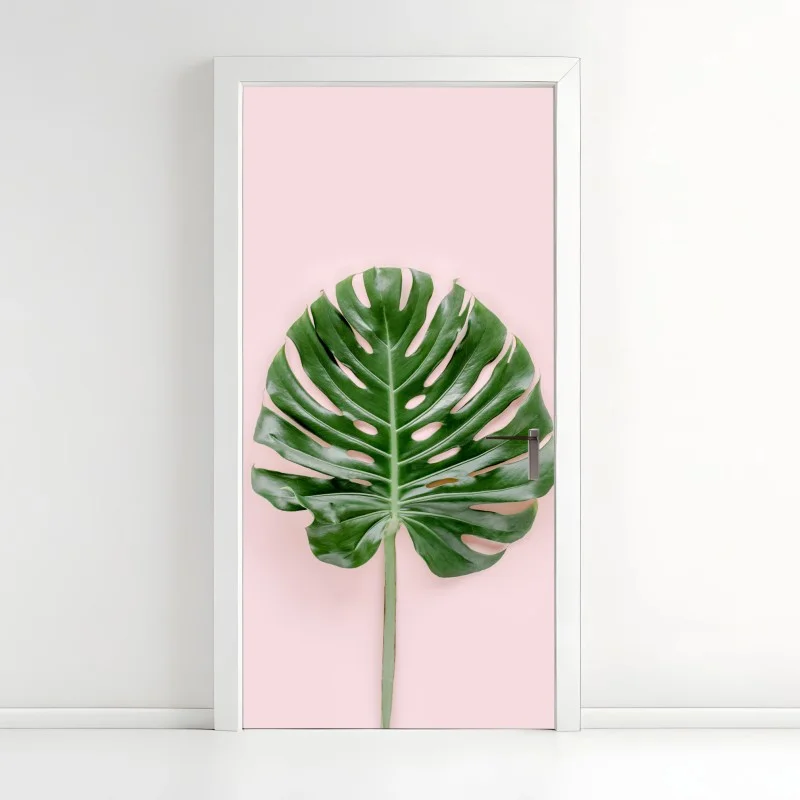 Pegatina para puerta hoja de monstera sobre fondo rosa