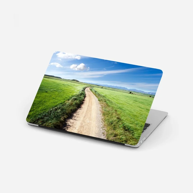 Pegatina para portátil camino campestre hacia montañas bajo cielo azul