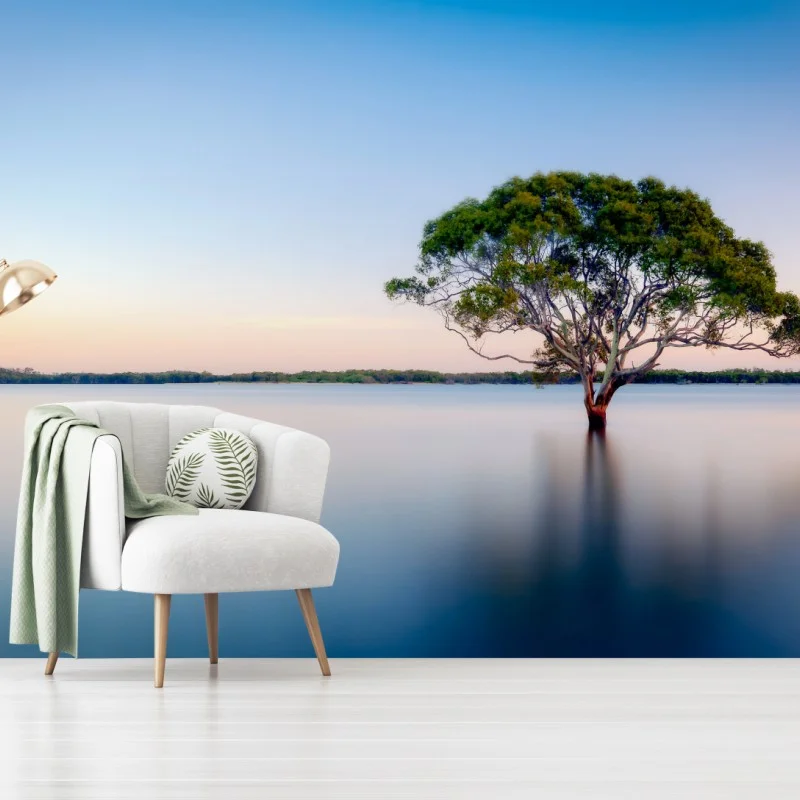Fotomural árbol solitario sobre agua en tonos pastel