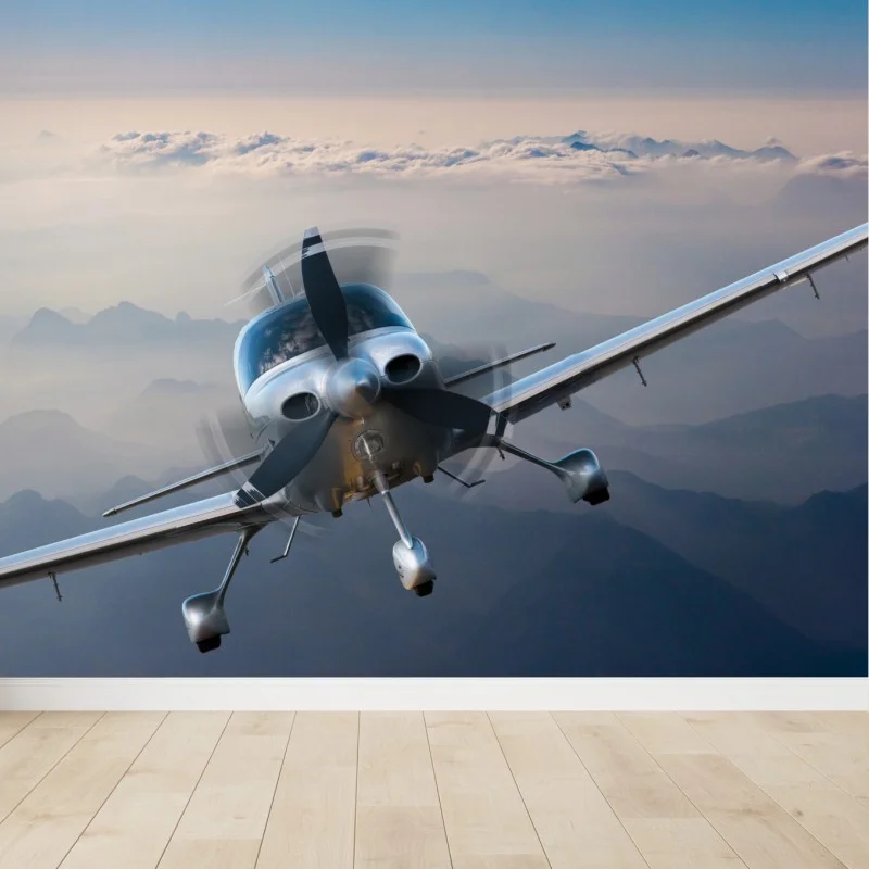 Fotomural avión monomotor sobre paisaje montañoso al amanecer