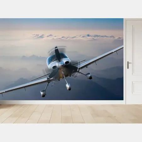 Fotomural avión monomotor sobre paisaje montañoso al amanecer – Pixers®