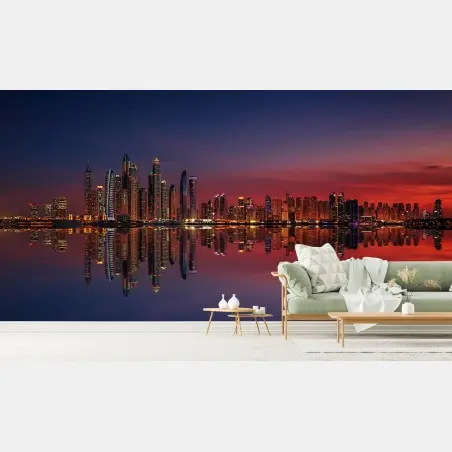 Fotomural skyline iluminado al atardecer con reflejos – Pixers®